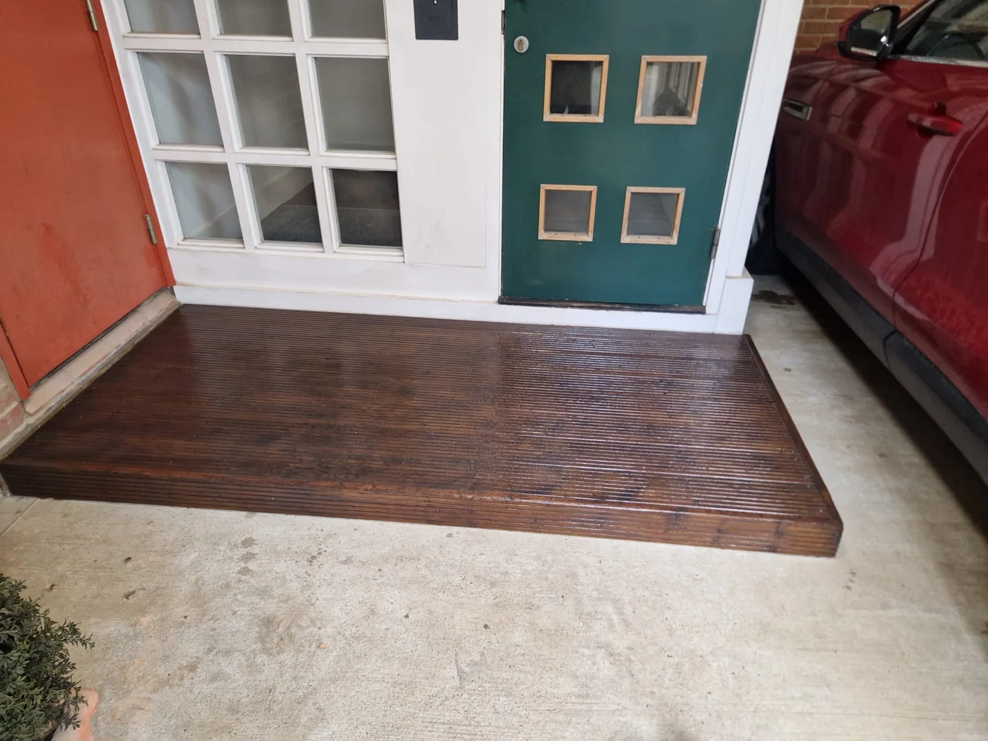 The completed entrance decking with its renewed woodstained finish.