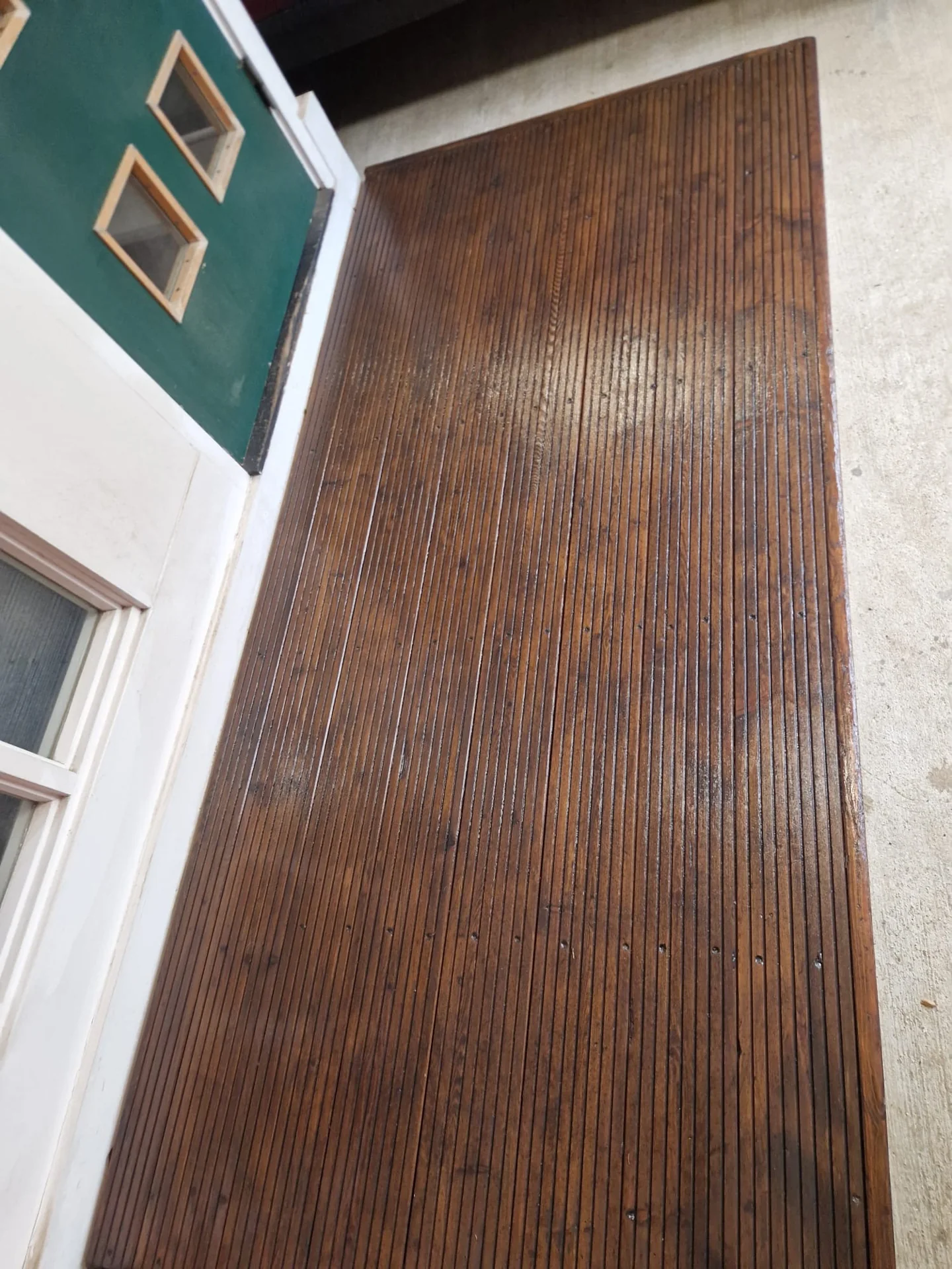 The renewed coating along the length of the decking.