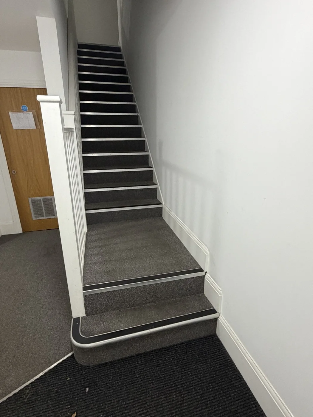 Communal staircase before the new wall-mounted handrails were installed.