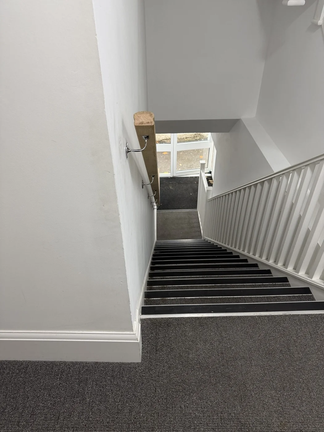 Installed main handrail and wall-mounted support brackets, viewed from above.